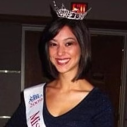 Jenise Fernandez, Miss Miami 2009, in formal attire on stage.