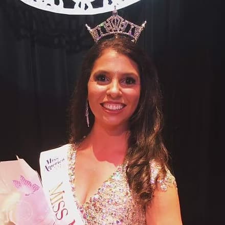 Ginelle Ruffa, Miss Miami Beach 2017, on stage in evening gown.