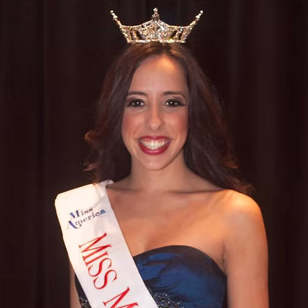 Stephanie Capon, Miss Miami Beach 2015, holding bouquet after win.